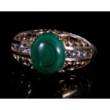 A 9ct gold ring set with central malachite cabochon. Approx UK size N