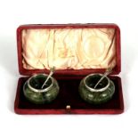 A pair of silver mounted turned Connemara green marble salts with shamrock finial spoons, London