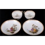 A pair of Meissen Marcolini period 1773-1814 teacups and saucers, decorated with figures in