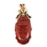 A Chinese jasper pendant in the form of Guanyin, 5cms (2ins) high.