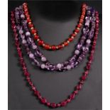 Three hardstone necklaces, amethyst; ruby; and carnelian, with crystal spacers and 9ct gold clasps.