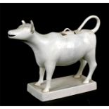 An 18th / 19th century Delft pottery oversized cow creamer in cream glaze, standing on a pedestal