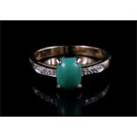 A 9ct gold ring, jade with diamond set shoulders.