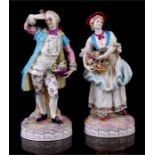 A pair of porcelain figures, a young couple with flower baskets, Meissen crossed swords mark to