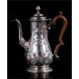 A Georgian embossed silver coffee pot by Alexander Johnston. Rubbed hallmark, appears to be London
