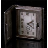 An Art Deco continental silver & enamel book form miniature clock with Arabic numerals and