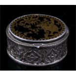 An Indian Pratapgarh white metal oval box, the green glass top inlaid with gold and depicting a