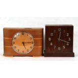 An Art Deco money box mantle clock; together with another similar (2).