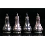 A set of four silver pepper castors, each 7cm (2.75ins) high. 83gms.