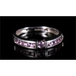 A 9ct white gold dress ring set with eleven pink stones. Approx UK size K