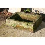 A carved stone plant trough, 74cms (29ins) wide.