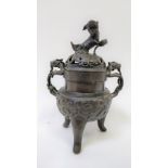 A Japanese bronze koro, with a lion finial and handles on a tripod base, 20.5cm high