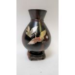 An early 20th century Japanese bronze vase inlaid with silver cranes, by Yoshiyuki Kokubi 25cm high