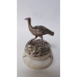 An electroplate and marble desk paperweight, of a running emu, on rocky outcrop, to a socle base,