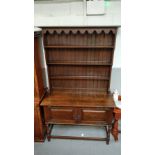 An Art Nouveau oak dresser, with fitted copper mounts and panelled top section, 205cm high, 122cm