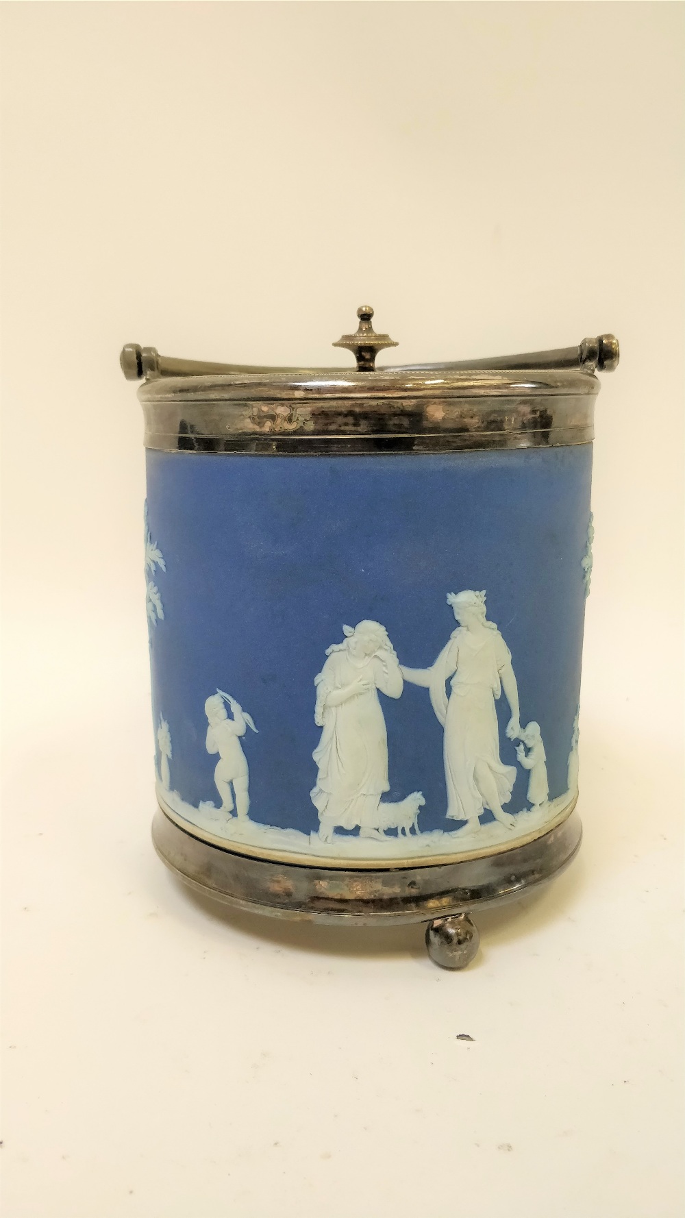 A Wedgwood blue jasperware biscuit barrel, decorated various figures, impressed marks, 15cm high