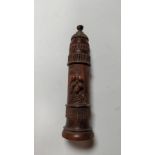 An early 20th century carved treen needle case, the front section carved with vine leaves and grapes