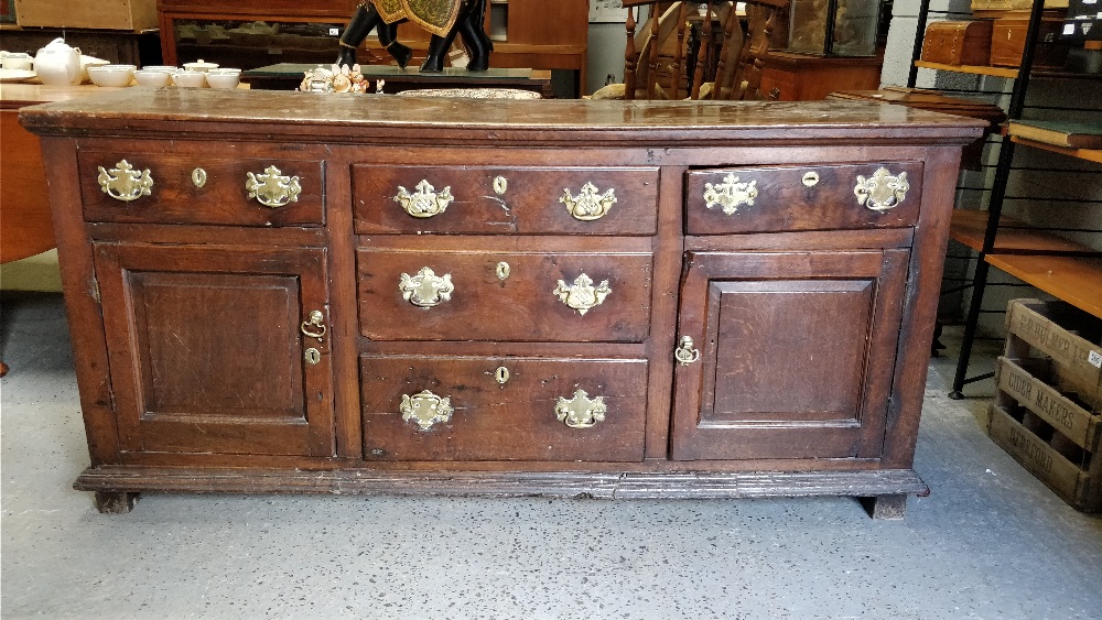 A 18th century oak dresser base, with fitted two cupboard section, three central short drawers and - Image 2 of 2