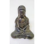 A Chinese bronze model of a seated female figure, with traces of original gilding, 11cm high