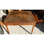 A Georgian writing desk with inlaid leather, drop leaf ends, on tapering legs and three lockable