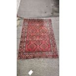 A large dahaj Iranian rug on a red ground with a repeated boarder throughout, 330cm x 206cm