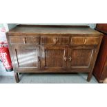 A 1930's oak sideboard, with two fitted cupboard sections and two fitted drawers by Heal's of