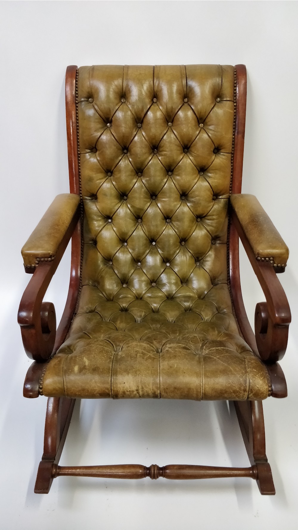 A 20th century green leather button back slipper chair