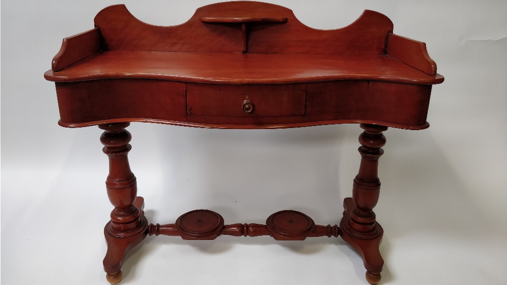 A mahogany serpentine dressing table, with a single drawer, 83cm high, 108cm long, 43cm wide