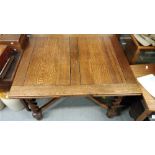 A 20th century oak extending dining table, with barley twist legs on bun feet, 73cm high, 122cm