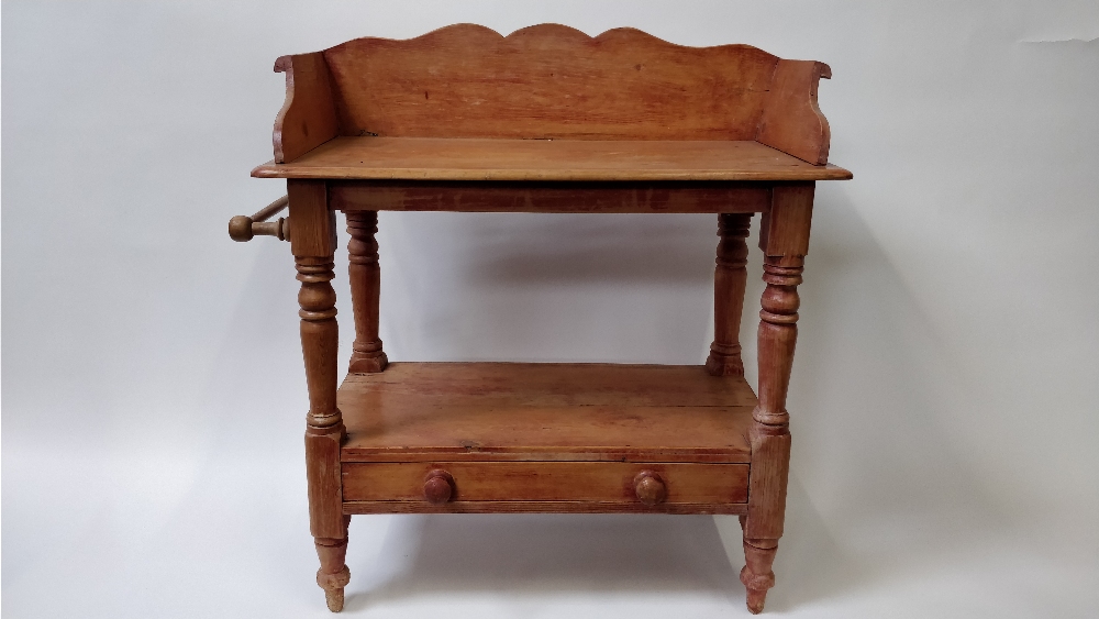 An early 20th century pine washstand, with single fitted drawer and side rail, 89cm high, 83cm long,