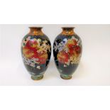 A pair of Chinese cloisonné vases, each decorated with a chrysanthemums, plants and other flowers on