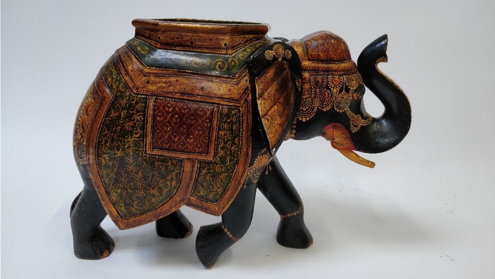 A 20th century painted hardwood model of an Indian elephant, 47cm high, 60cm long