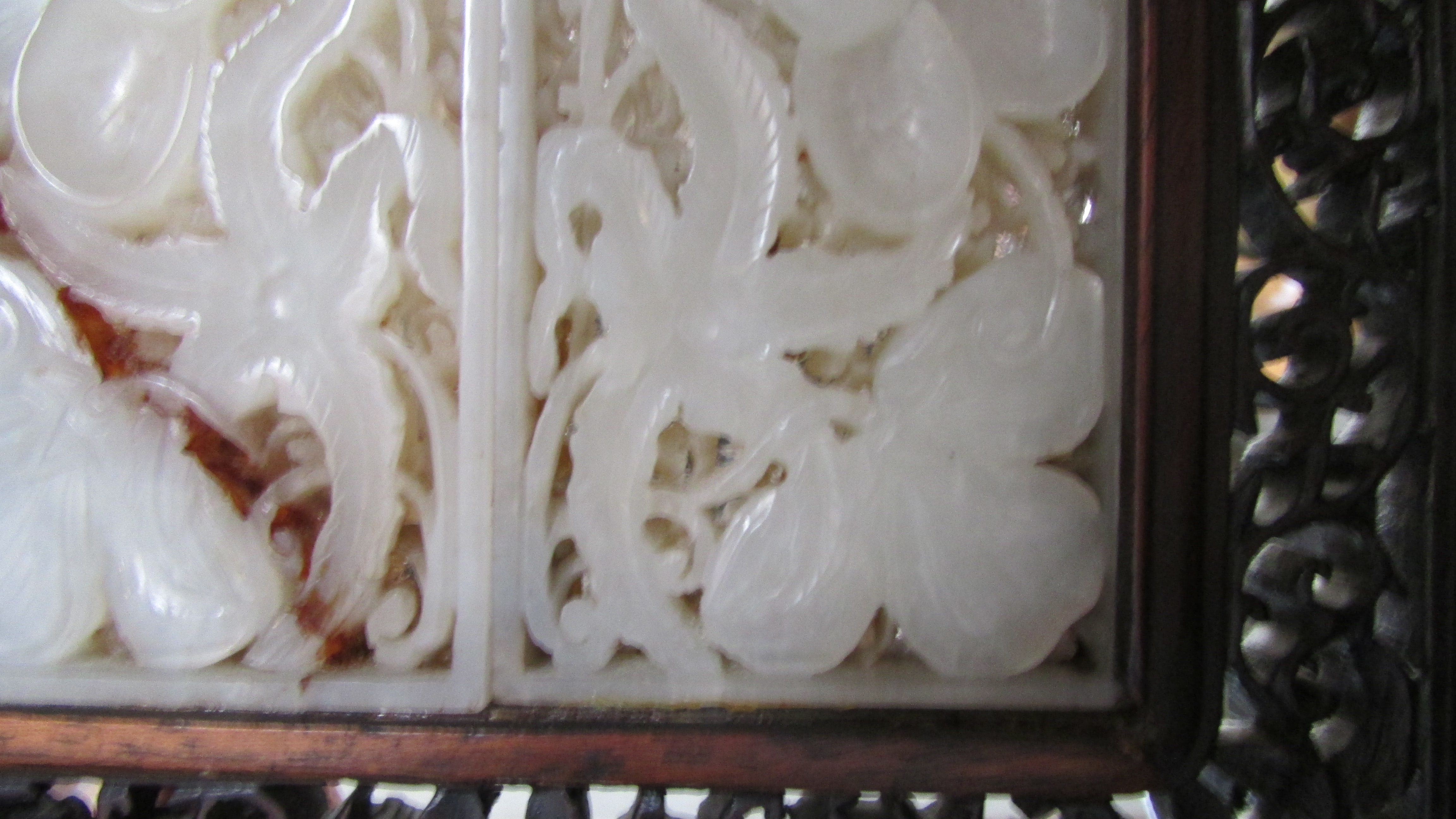 A 20th century Chinese table screen, the white jade panel decorated with flowers in a hardwood frame - Image 4 of 7
