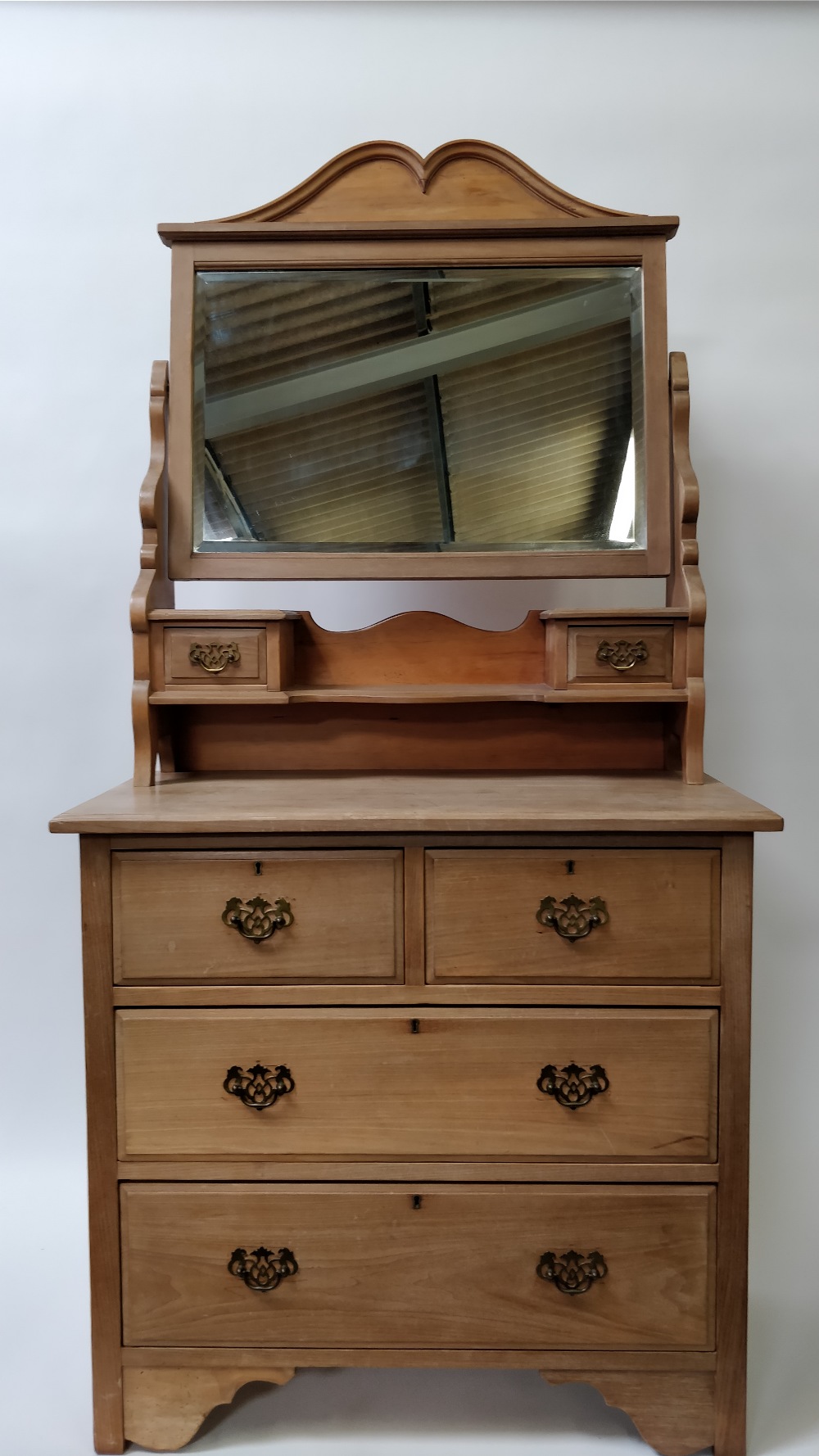 An early 20th century pine dressing table, with a detachable mirror, with brass drop handles,