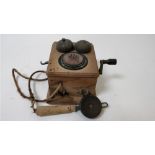 A 20th century wall telephone in a wooden casing