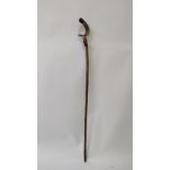 A large walking stick, top carved with a horn handle in the form of a fish