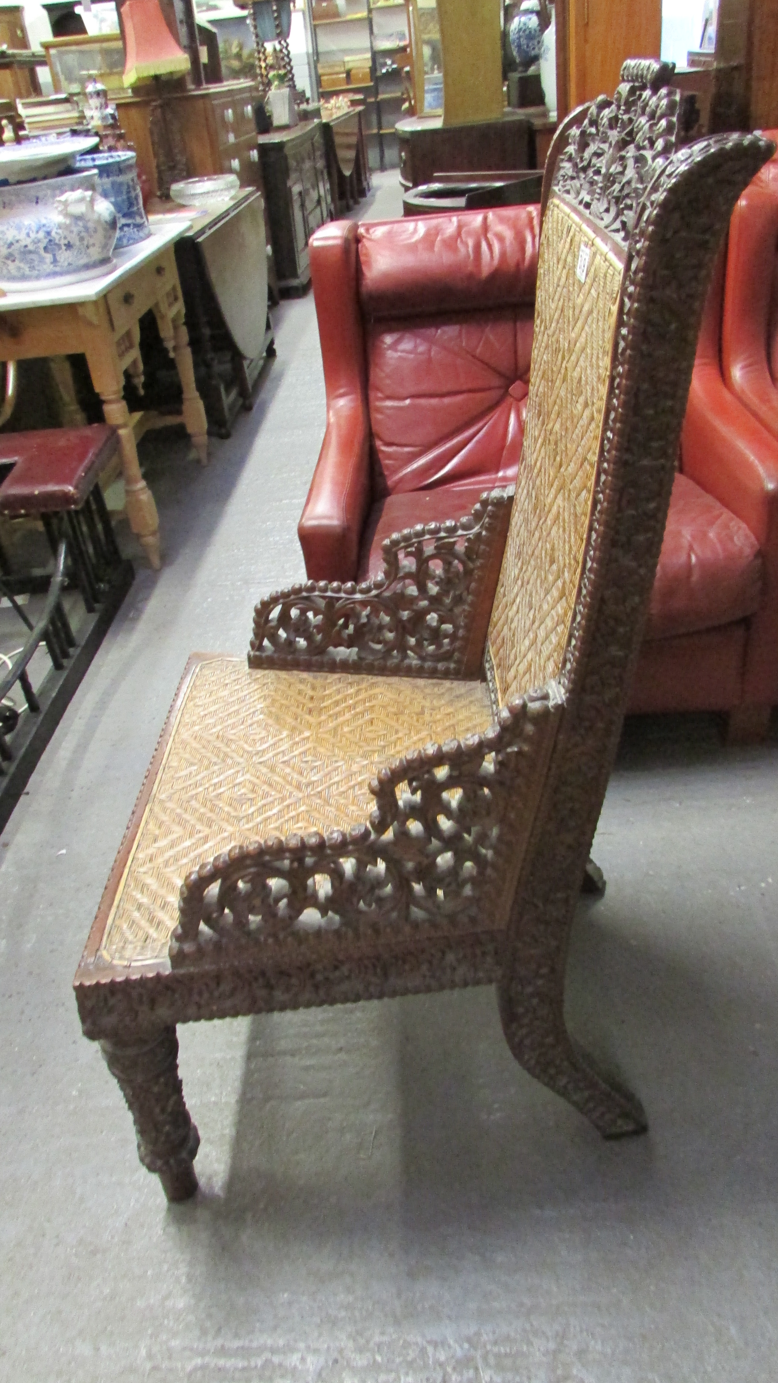 A 19th century Anglo Indian carved hardwood chair with a wicker seat and back - Image 3 of 7