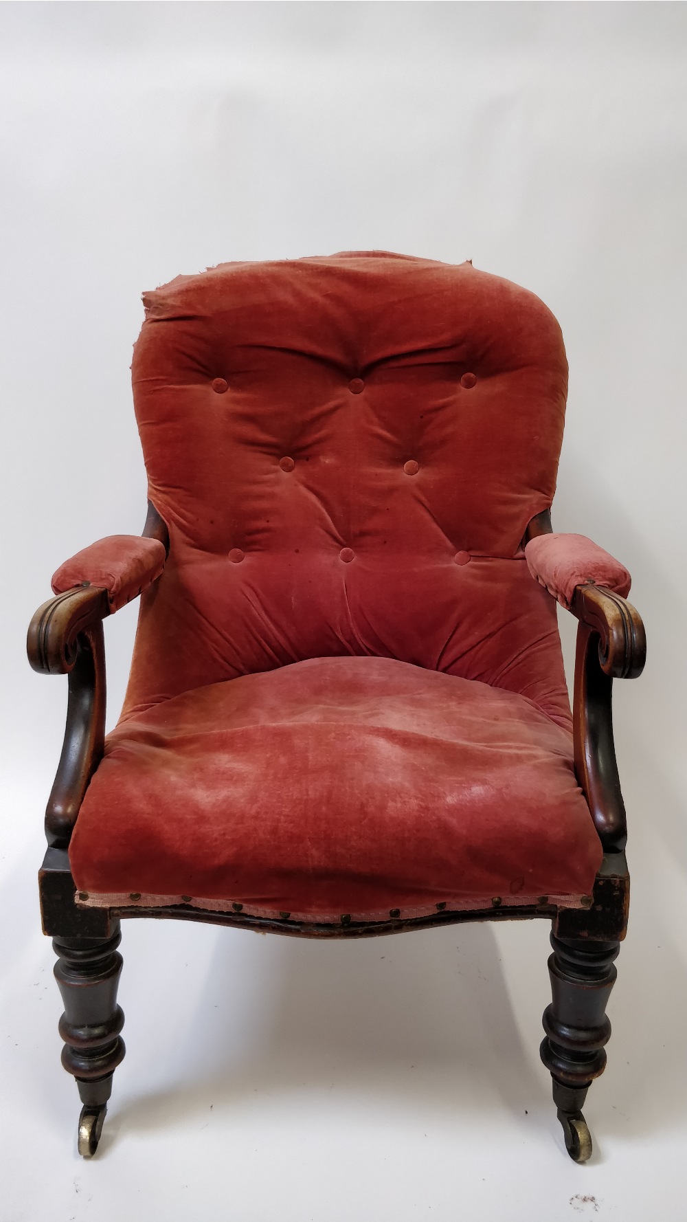 An Edwardian mahogany button nursing chair