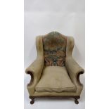 A 20th century armchair with a needlework back of a male and female, on a walnut frame