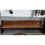 An early 20th century pine church pew, 81cm high, 266cm long, 48cm deep