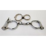 Two pairs of mid 20th century chromed police handcuffs