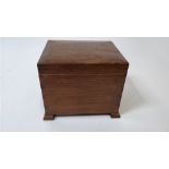 A 1930's oak box on stand, with a fitted tray, raised on four bracket feet, 24cm high, 28cm long,