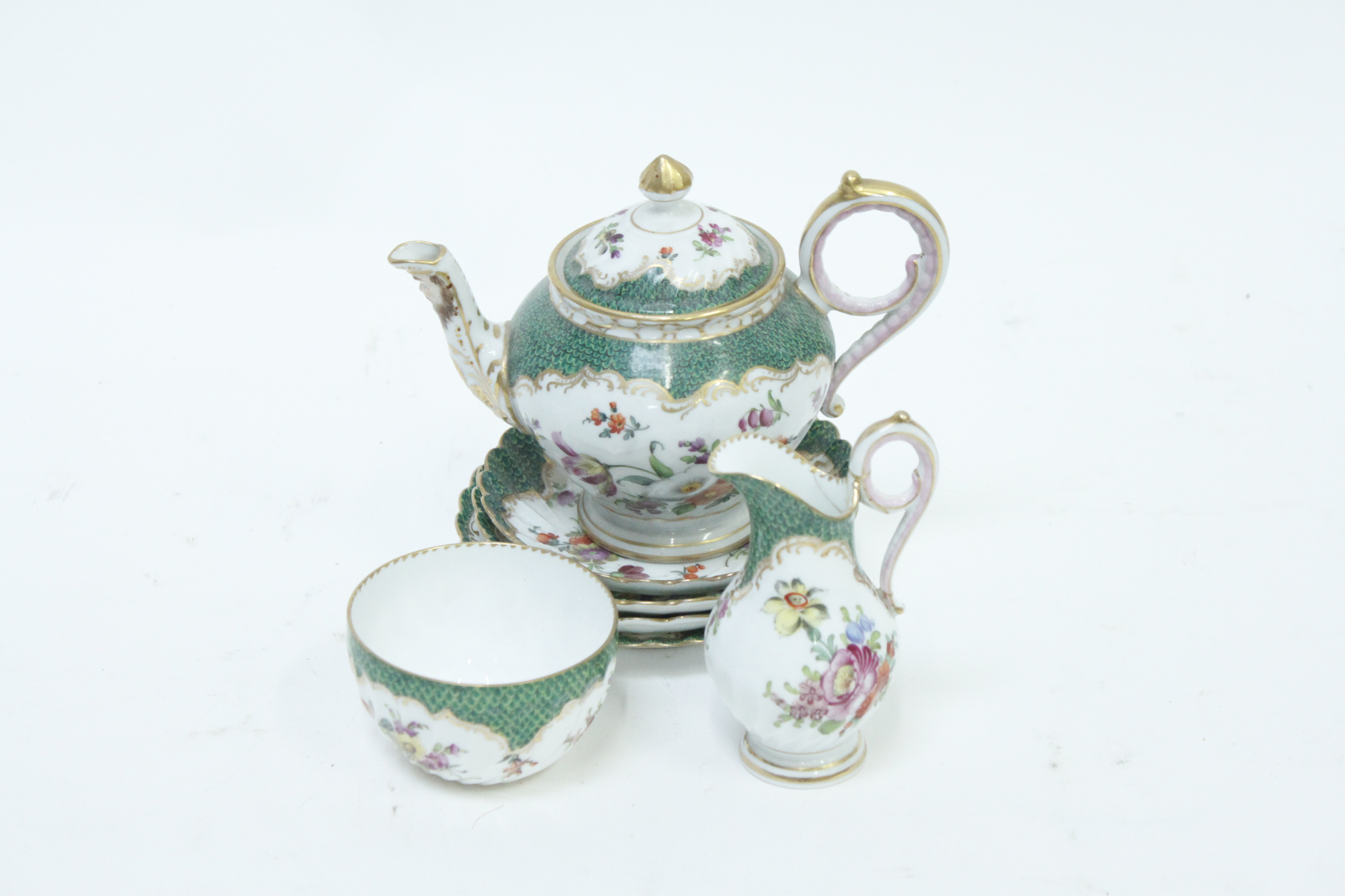 A Dresden teapot, cream jug, sugar bowl and four saucers