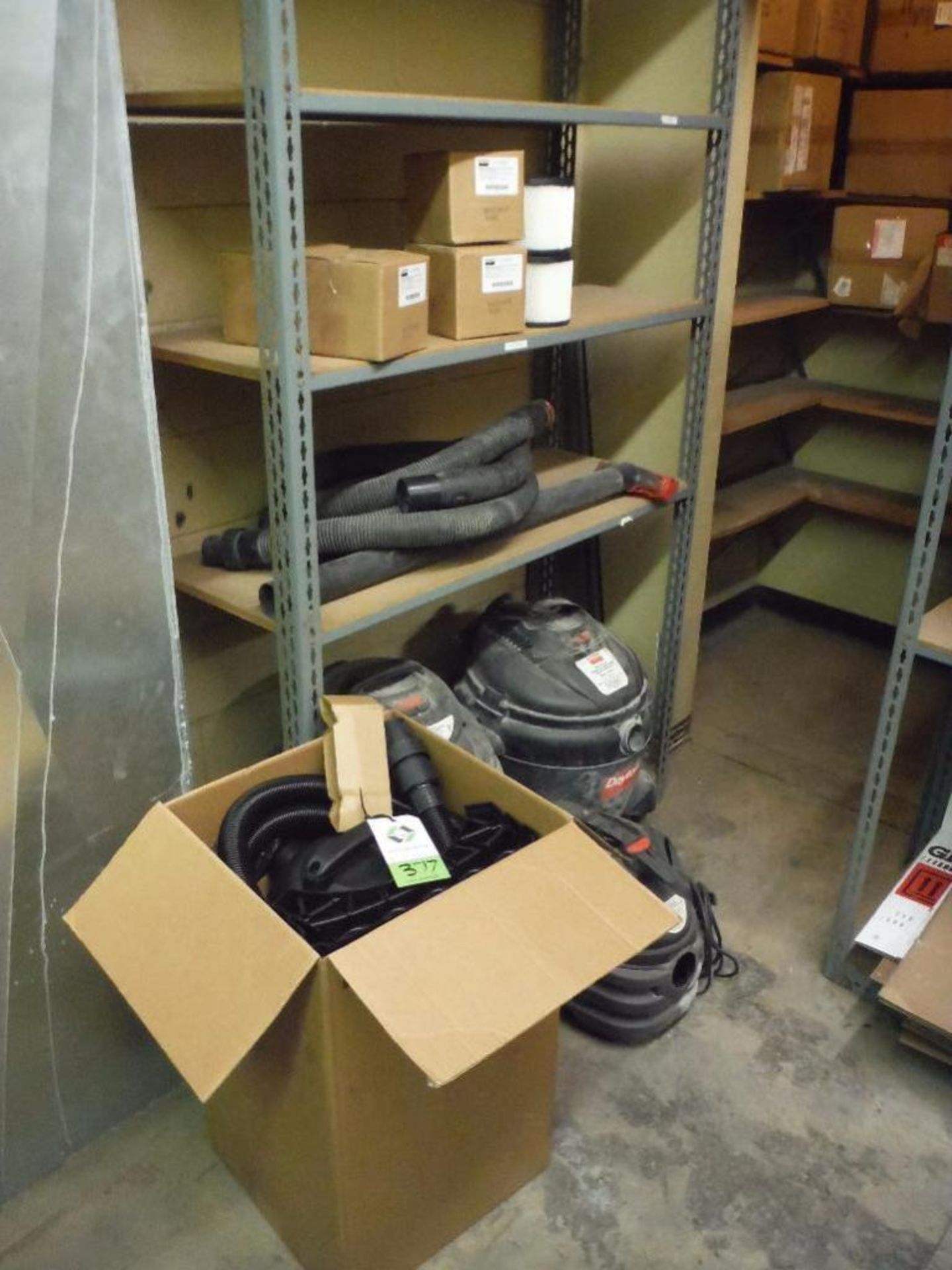 Contents of 1 sections of shelving, new in box Dayton shop vac, multiple used shop vacs ** Rigging