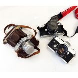 Quantity of cameras and lenses including a Pentax Asahi ME SLR camera, a Canon FTQL SLR camera,