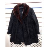 A black astrakhan coat with dark mink collar, Marshall & Snelgrove,