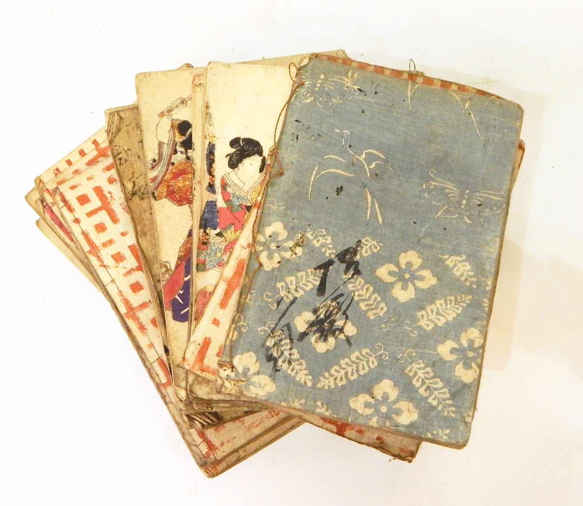 Selection of Japanese booklets on handmade paper with woodblock prints, some covers coloured,