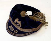 Blue velvet rugby cap embroidered with a lion emblem and the peak dated 1930-31,