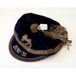 Blue velvet rugby cap embroidered with a lion emblem and the peak dated 1930-31,