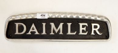 Daimler alloy radiator name plate, 39cm long and two other metal vehicle plates, one inscribed "CM",